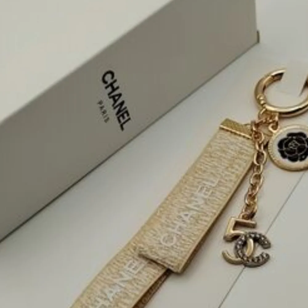 CHANEL Paris Gold-Tone Key Holder with Beige Ribbon and Camellia Charm